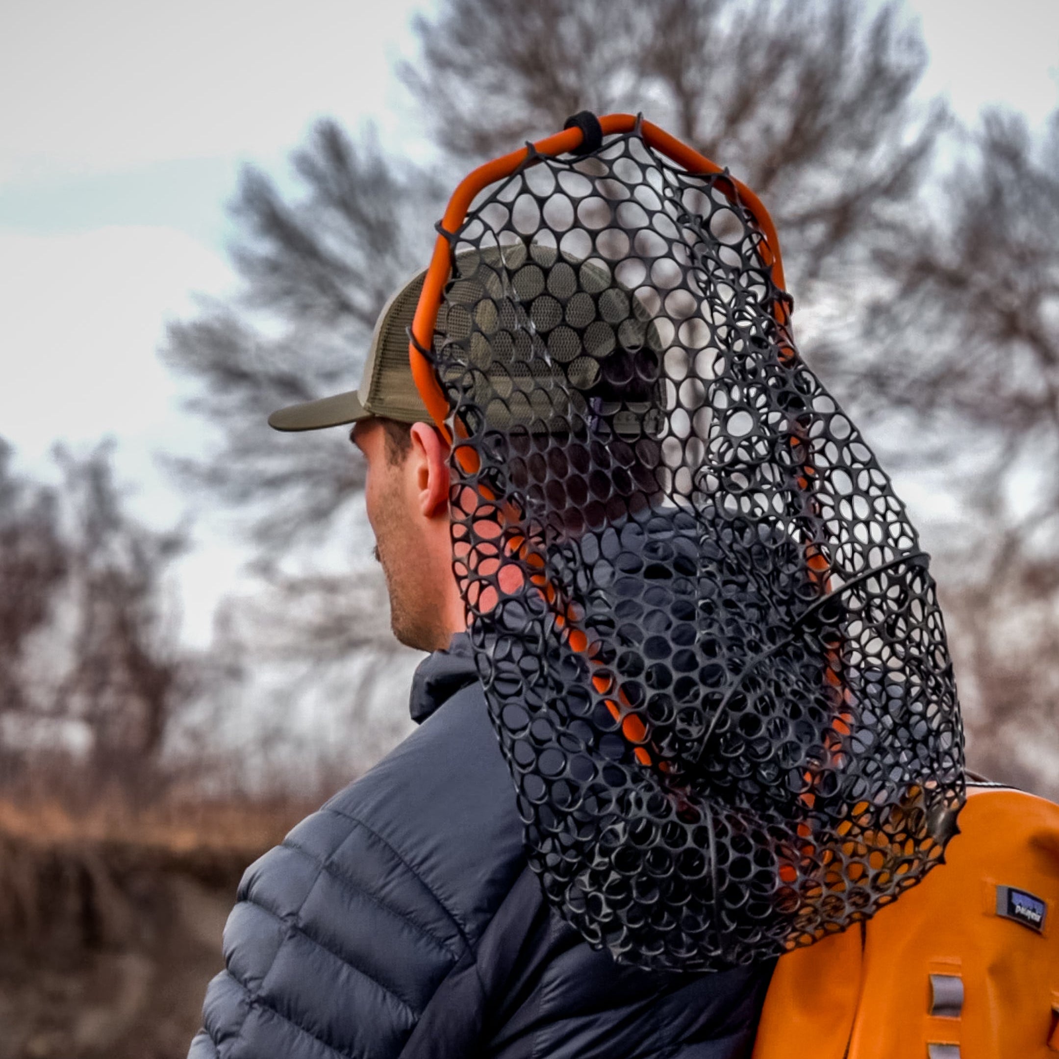 Angler with fishing net on their back (global).